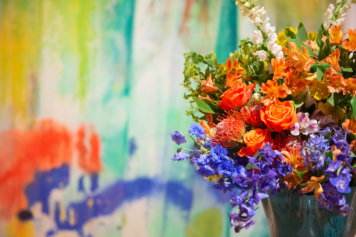 A bouquet of flowers in front of a painting