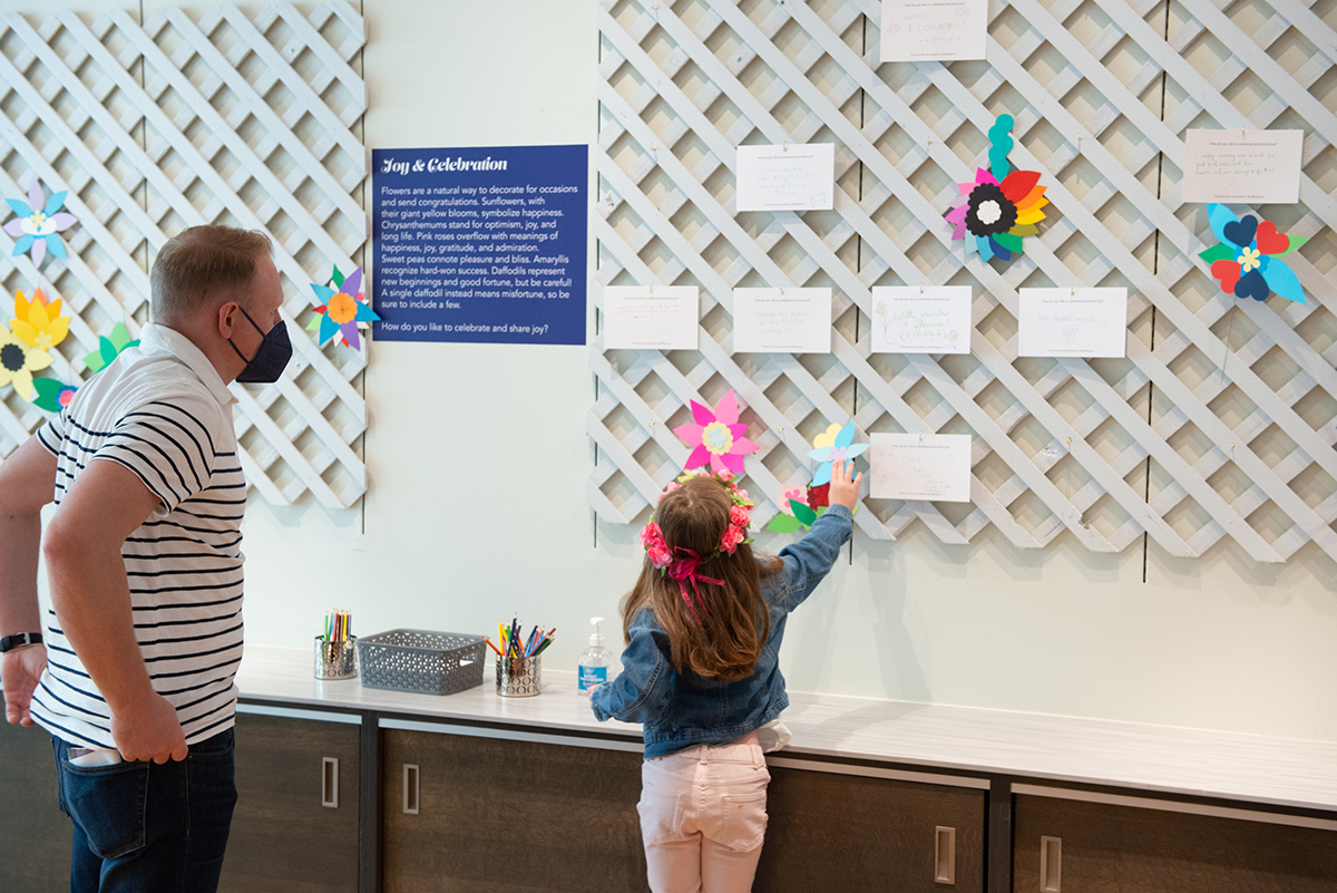 A father and daughter participating in an exhibit activity