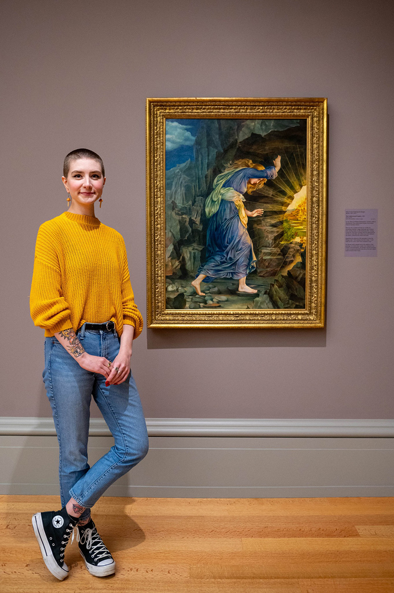 True standing next to the painting