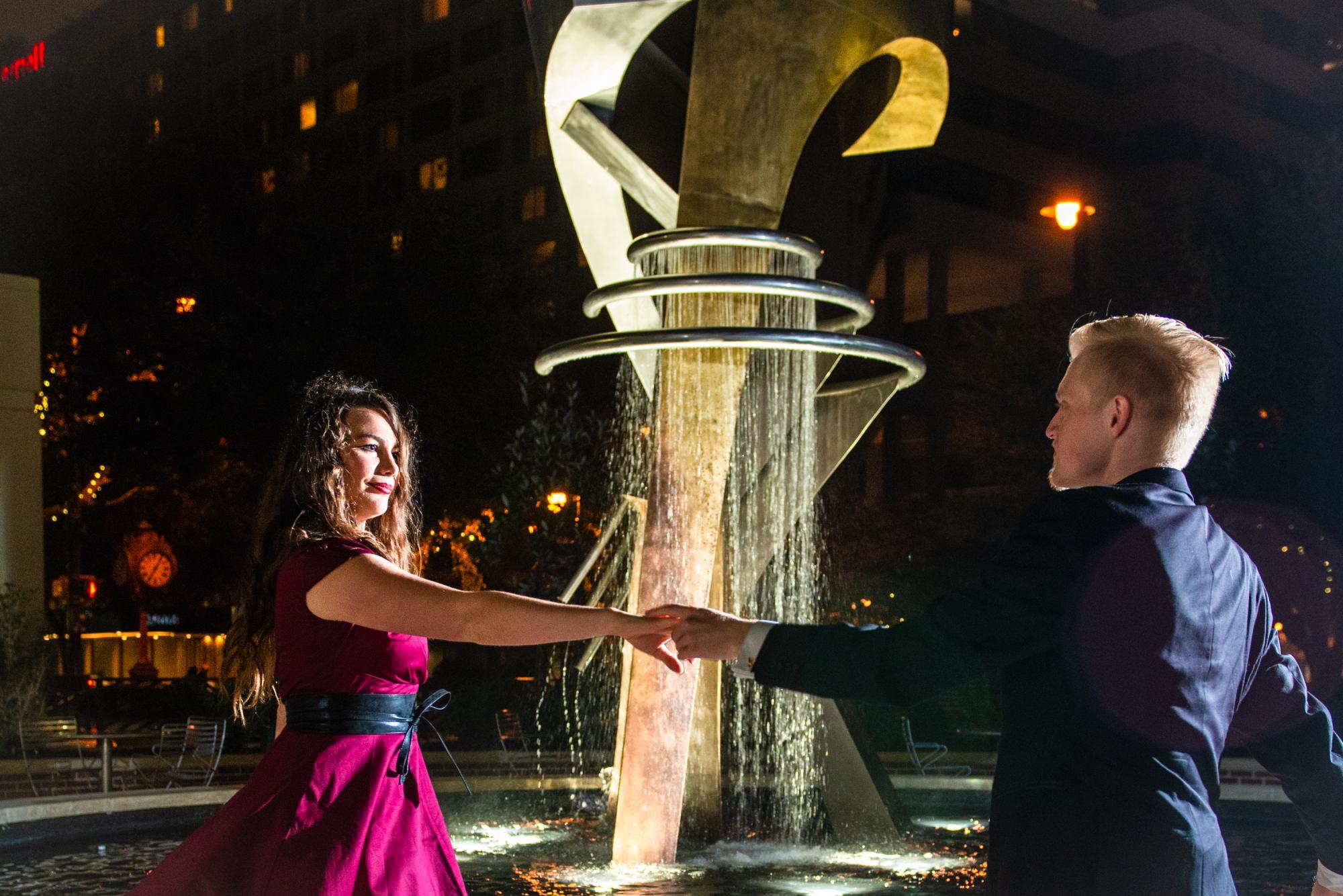 couple dancing in front of fountain