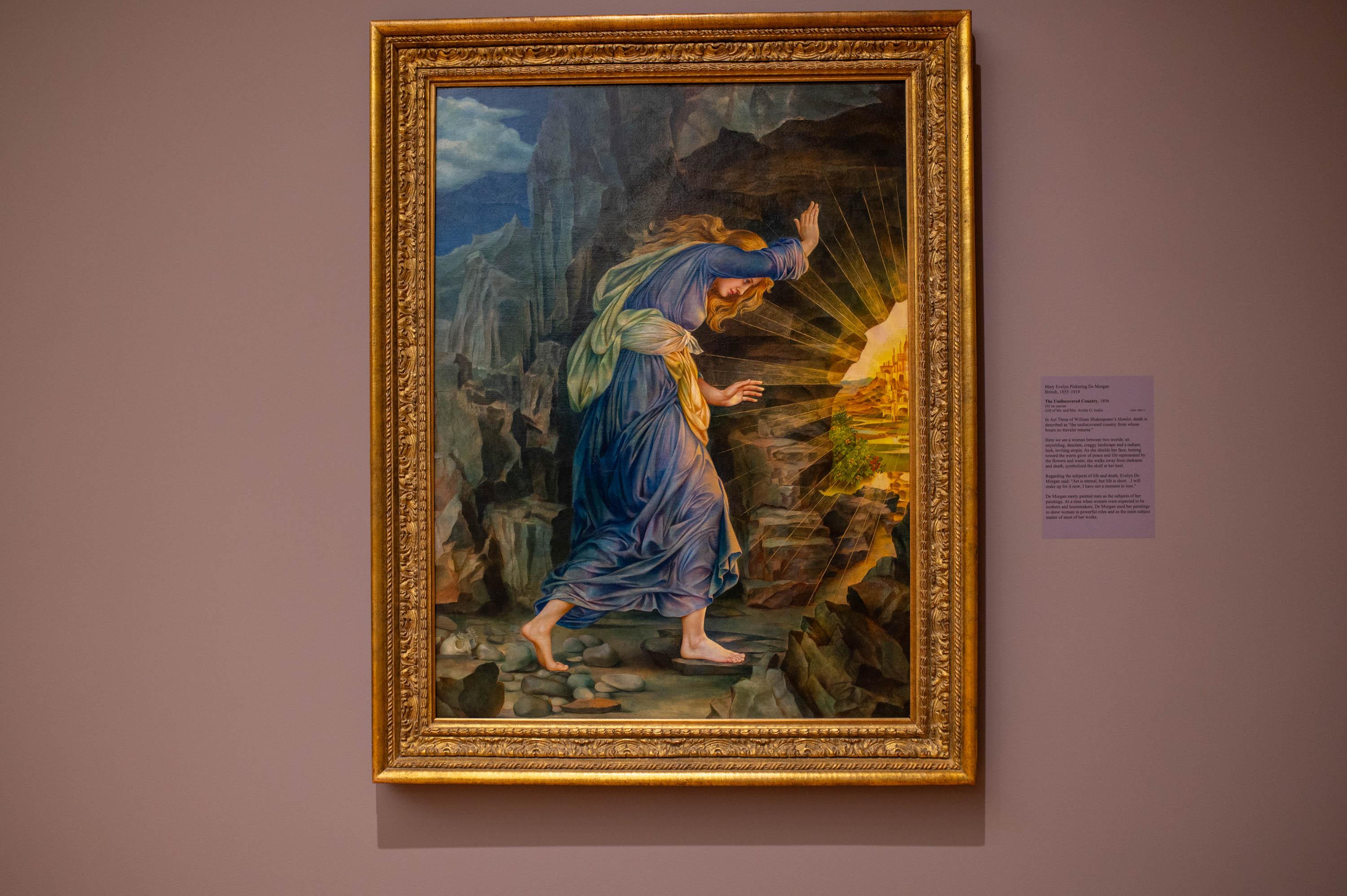 Mary Evelyn Pickering De Morgan's The Undiscovered Country". Painting that includes a white woman, in a mountain scenery, dressed in blue dress blocking face from light glaring from right side of painting