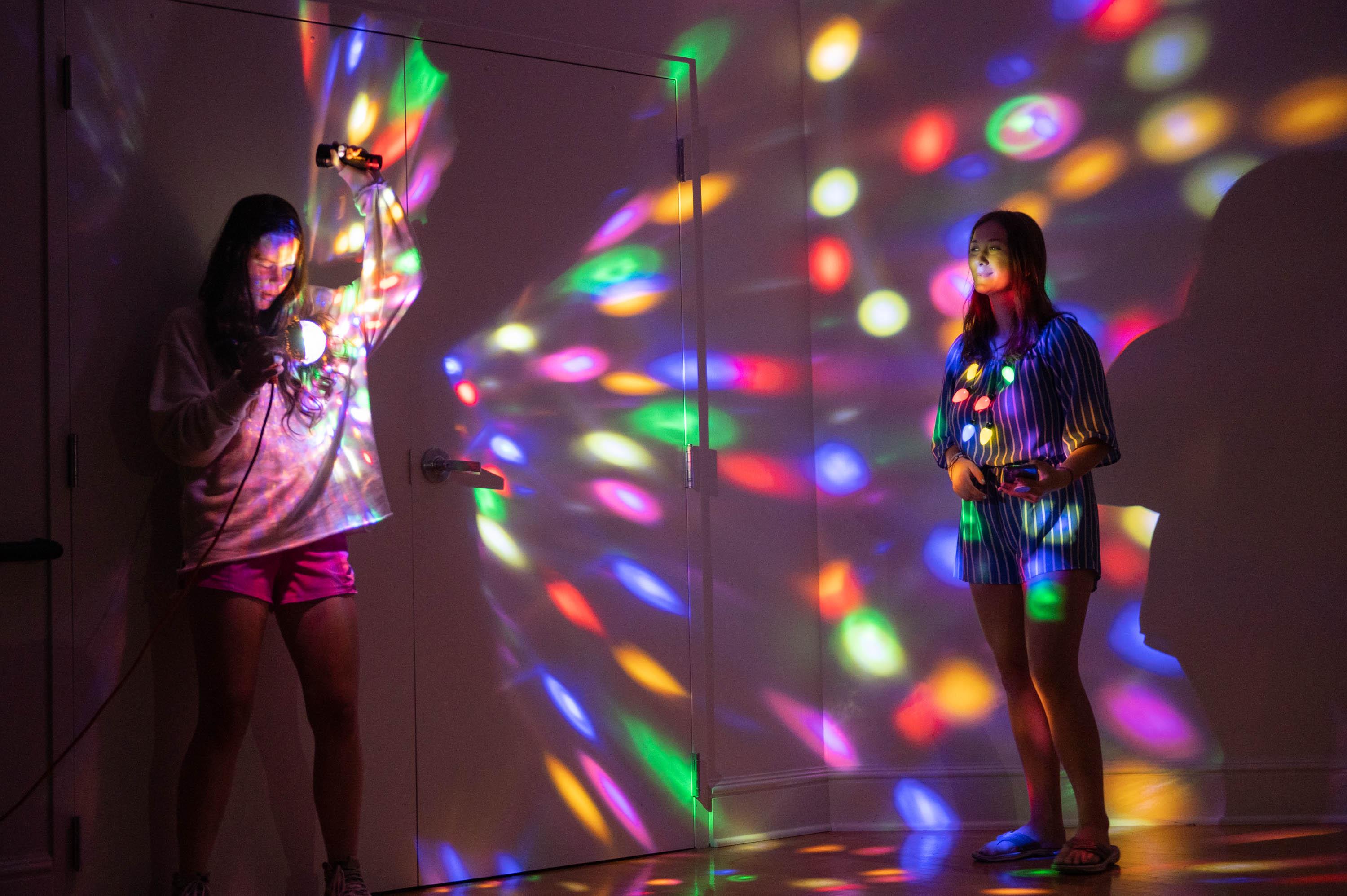 Teens experimenting with colored lights in a photograph