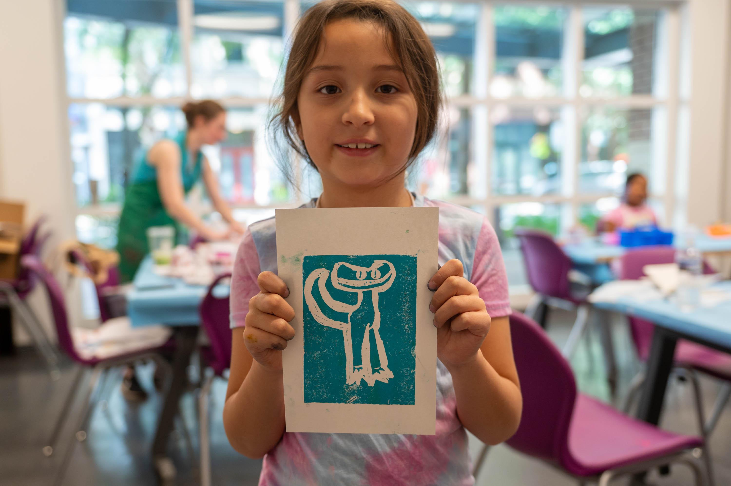 a camper showing off her print