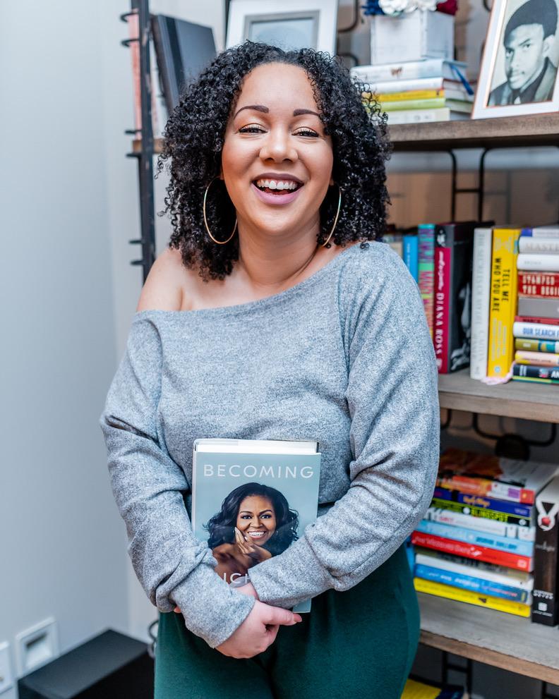 Host Jemia Williams standing in front of her bookshelves